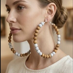 Large hoop earrings featuring wooden beads. Super lightweight and easy to wear.